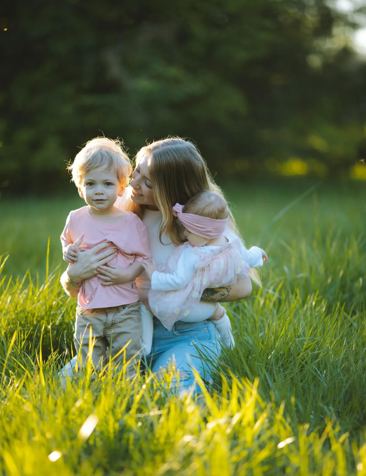 A parent spending time outdoors with two children